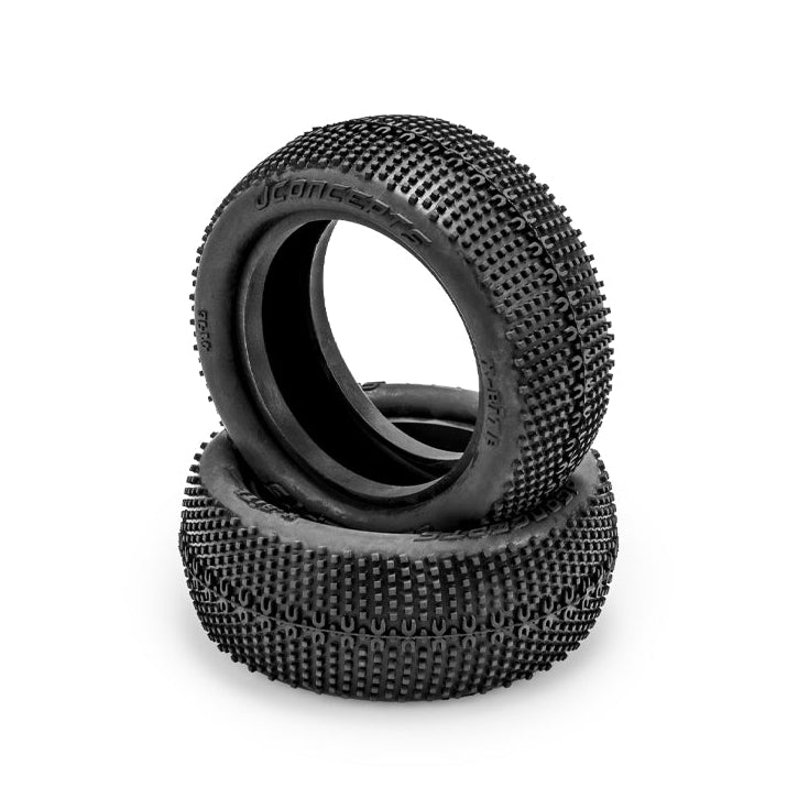 Two black rubber off-road tires stacked on a white background, featuring a deep knobby tread pattern and visible 'JCONCEPTS' branding on the sidewall.